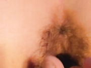 Toying her hairy twat